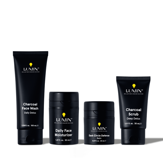 Lumin men's skincare set with Charcoal Face Wash, Daily Face Moisturizer, Dark Circle Defense Balm, and Charcoal Scrub.