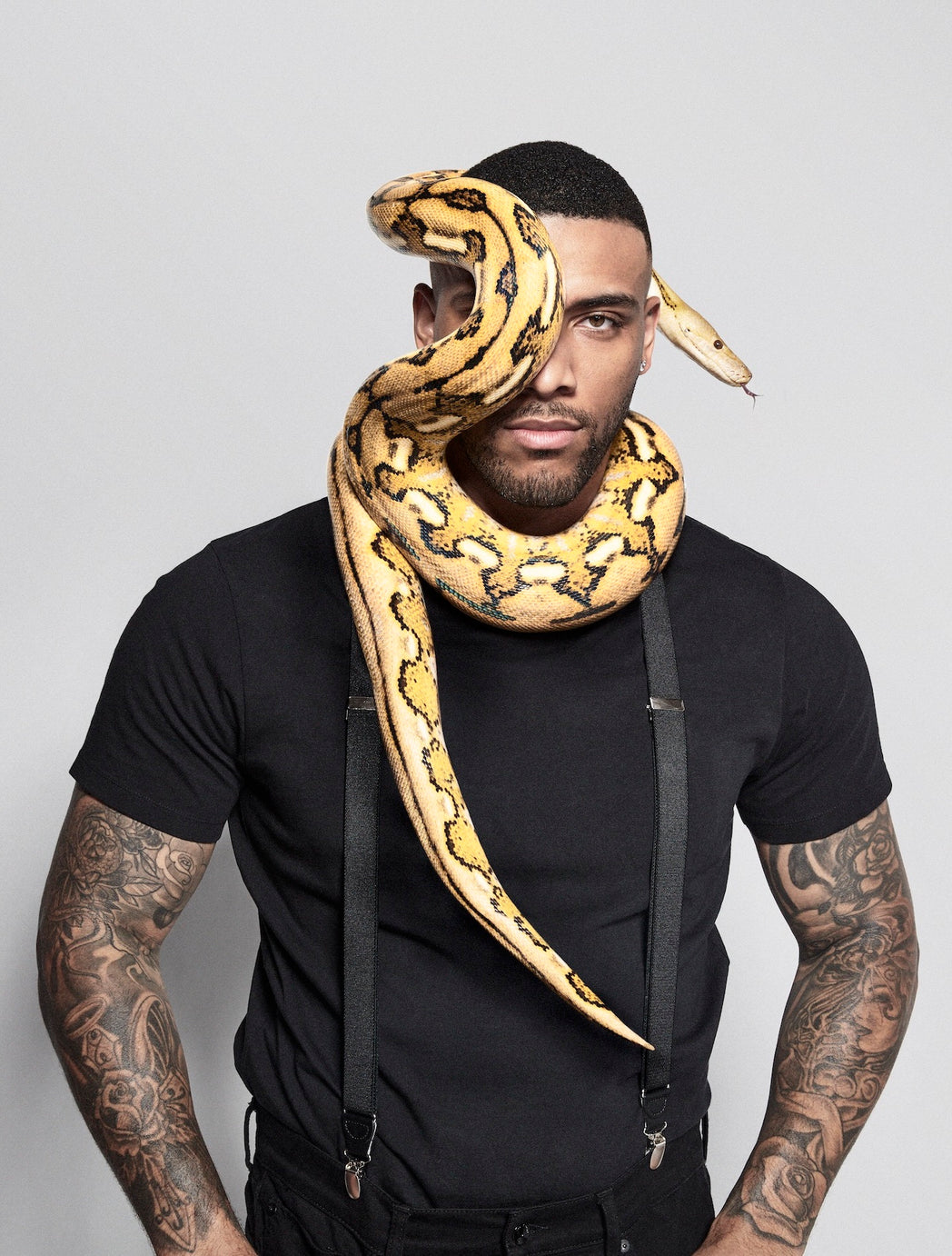 Claude George with snake wrapped around neck