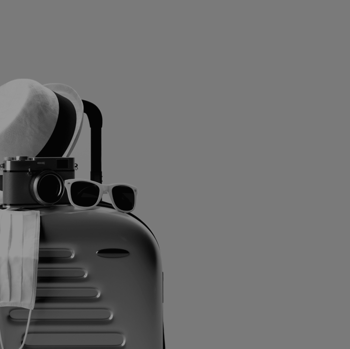 Black hard-shell suitcase with white fedora, black camera, white sunglasses, and a hanging face mask on gray background.