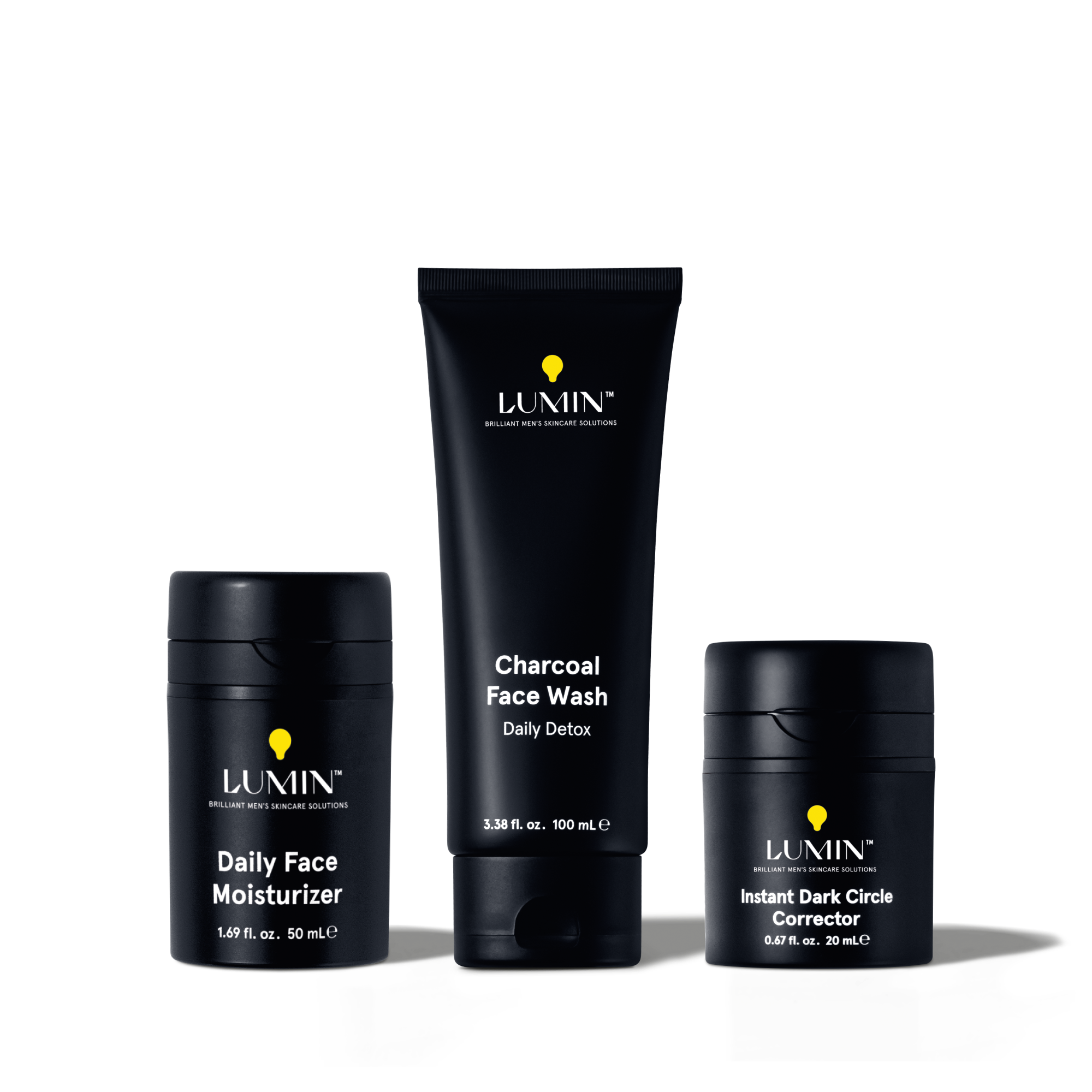 Lumin men's skincare set with charcoal face wash, daily face moisturizer, and instant dark circle corrector in black packaging