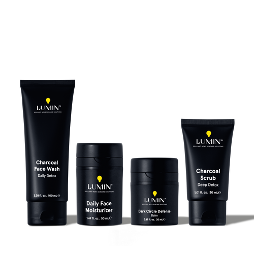Lumin men's skincare set with Charcoal Face Wash, Daily Face Moisturizer, Dark Circle Defense Balm, and Charcoal Scrub.