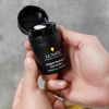 Lumin Instant Redness Corrector in black container held in hand, men's skincare cream for redness relief, 30ml.
