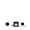 White and black geometric shape blocks with circle, triangle, and square cutouts on black background for educational use.