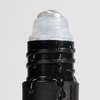 Black roll-on deodorant with water droplets on the applicator, emphasizing freshness and moisture-resistant design.