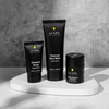 Lumin men's charcoal skincare set featuring Charcoal Scrub, Charcoal Face Wash, and Instant Redness Corrector on white platform